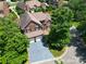 Aerial view of the brick two-story home with a well-manicured lawn and mature trees at 10418 Pullengreen Dr, Charlotte, NC 28277