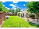 Expansive backyard featuring a pergola, brick wall, and lush lawn at 10418 Pullengreen Dr, Charlotte, NC 28277