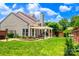 Lush backyard with a patio, pergola, and well-maintained lawn, perfect for outdoor entertaining at 10418 Pullengreen Dr, Charlotte, NC 28277