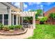 Lovely backyard showcasing a pergola patio, lush greenery, and manicured garden beds at 10418 Pullengreen Dr, Charlotte, NC 28277