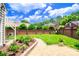 Spacious backyard featuring a brick perimeter, lush lawn, patio and mature landscaping at 10418 Pullengreen Dr, Charlotte, NC 28277