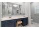 Well-lit bathroom features a vanity with makeup area, drawers and a large mirror at 10418 Pullengreen Dr, Charlotte, NC 28277
