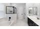Bright bathroom with soaking tub, glass enclosed shower, and double sink vanity at 10418 Pullengreen Dr, Charlotte, NC 28277