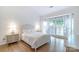 Serene bedroom with neutral decor, large windows, hardwood floors, and ample natural light at 10418 Pullengreen Dr, Charlotte, NC 28277
