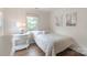 Bright bedroom with hardwood floors, side table, and windows with natural light at 10418 Pullengreen Dr, Charlotte, NC 28277