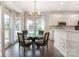 Charming breakfast nook boasting abundant natural light, modern lighting, and a breakfast bar at 10418 Pullengreen Dr, Charlotte, NC 28277