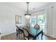 Bright dining room with chandelier, a dark wooden table with seating, and natural light at 10418 Pullengreen Dr, Charlotte, NC 28277