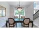 Traditional dining room featuring an elegant chandelier, dark wood table, and bright natural light at 10418 Pullengreen Dr, Charlotte, NC 28277