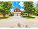 Beautiful brick home with well-manicured lawn, mature trees, and a two-car garage at 10418 Pullengreen Dr, Charlotte, NC 28277