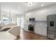 Bright kitchen featuring white cabinetry, stainless steel appliances, and a breakfast bar at 10418 Pullengreen Dr, Charlotte, NC 28277