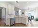 Well-lit kitchen area showcasing white cabinets, modern appliances, and easy access to the dining nook at 10418 Pullengreen Dr, Charlotte, NC 28277