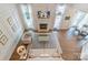 Spacious living room with fireplace, tall windows, and modern decor at 10418 Pullengreen Dr, Charlotte, NC 28277
