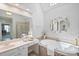 Bright bathroom features a soaking tub, separate shower, double sink, and a skylight at 11335 Wescott Hill Dr, Huntersville, NC 28078