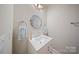 Bathroom featuring a modern vanity, decorative mirror, and stylish blue towels at 11335 Wescott Hill Dr, Huntersville, NC 28078