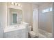 Bright bathroom features a shower/tub combo, neutral walls, and a white vanity at 11335 Wescott Hill Dr, Huntersville, NC 28078