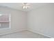 Cozy bedroom with neutral carpet and walls has a window and ceiling fan at 11335 Wescott Hill Dr, Huntersville, NC 28078