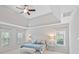 Bright bedroom with tray ceilings, large windows, and neutral-colored walls and carpet at 11335 Wescott Hill Dr, Huntersville, NC 28078