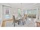 Elegant dining room featuring hardwood floors, decorative columns, and a stylish chandelier above a table setting at 11335 Wescott Hill Dr, Huntersville, NC 28078
