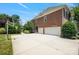 Exterior with a basketball hoop, large driveway, and three-car garage offers ample parking and recreational space at 11335 Wescott Hill Dr, Huntersville, NC 28078