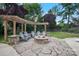 Inviting backyard fire pit with stone surround and pergola creates a cozy outdoor gathering space at 11335 Wescott Hill Dr, Huntersville, NC 28078
