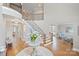 Grand foyer with a curved staircase, hardwood floors, and elegant decor creates a welcoming entrance at 11335 Wescott Hill Dr, Huntersville, NC 28078