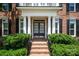 Inviting front entrance with brick steps, manicured shrubs, and an elegant double door with glass panels at 11335 Wescott Hill Dr, Huntersville, NC 28078