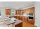 Well-lit kitchen with stainless steel appliances, wood cabinets, and a breakfast bar area at 11335 Wescott Hill Dr, Huntersville, NC 28078