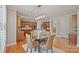 Eat-in kitchen with stainless steel appliances, center island, wood cabinetry, and a pendant light fixture at 11335 Wescott Hill Dr, Huntersville, NC 28078