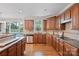 Spacious kitchen features wood cabinetry, stainless appliances, and views of the swimming pool from the window at 11335 Wescott Hill Dr, Huntersville, NC 28078
