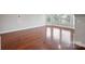 Bright living room featuring gleaming hardwood floors and ample natural light from large windows at 11335 Wescott Hill Dr, Huntersville, NC 28078