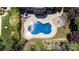 Aerial view of a backyard featuring a sparkling pool, patio, and well-manicured landscaping at 11335 Wescott Hill Dr, Huntersville, NC 28078