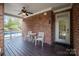 Covered porch with ceiling fan, chairs and view of the backyard at 11335 Wescott Hill Dr, Huntersville, NC 28078