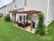 Relaxing backyard patio with comfortable seating under a wooden pergola at 11511 Wilson Mill Ln, Pineville, NC 28134