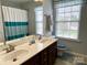 Bathroom featuring a dual sink vanity and separate shower at 11511 Wilson Mill Ln, Pineville, NC 28134