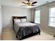 Bedroom with plush carpeting, a ceiling fan, and two windows at 11511 Wilson Mill Ln, Pineville, NC 28134
