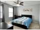 Cozy bedroom with a ceiling fan, large window, and neutral paint at 11511 Wilson Mill Ln, Pineville, NC 28134