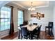 Bright dining room featuring hardwood floors, chandelier, and large windows at 11511 Wilson Mill Ln, Pineville, NC 28134