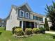 Charming two-story home featuring professional landscaping, a manicured lawn, and a welcoming facade at 11511 Wilson Mill Ln, Pineville, NC 28134