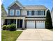 Charming two-story home with a well-manicured lawn and a two-car garage at 11511 Wilson Mill Ln, Pineville, NC 28134