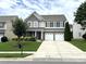 Attractive two-story home showcasing a well-kept lawn and a two-car garage at 11511 Wilson Mill Ln, Pineville, NC 28134