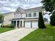 Charming two-story home featuring a two-car garage and a well-maintained lawn at 11511 Wilson Mill Ln, Pineville, NC 28134