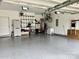 Spacious two car garage with clean epoxy flooring and storage shelving at 11511 Wilson Mill Ln, Pineville, NC 28134