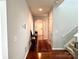 Hallway with hardwood floors, stairs, and an archway leading to the entryway at 11511 Wilson Mill Ln, Pineville, NC 28134