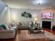 Comfortable living room featuring a fireplace, sofas, artwork, and a decorative rug at 11511 Wilson Mill Ln, Pineville, NC 28134