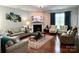Inviting living room with a fireplace, hardwood floors, and comfortable seating at 11511 Wilson Mill Ln, Pineville, NC 28134