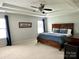 Large main bedroom with a tray ceiling, ceiling fan, and carpeting at 11511 Wilson Mill Ln, Pineville, NC 28134