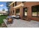 Brick home backyard with a fire pit, paved patio, steps to enter the home, and manicured lawn at 121 Canterbury Xing, Fort Mill, SC 29708