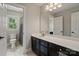 Well-lit bathroom features a vanity with a large mirror and a shower at 121 Canterbury Xing, Fort Mill, SC 29708