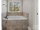 Elegant soaking tub with tile surround, perfect for relaxation and rejuvenation at 121 Canterbury Xing, Fort Mill, SC 29708