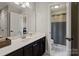 Bathroom featuring double sink vanity, white countertops, modern fixtures, and a view to the adjacent room at 121 Canterbury Xing, Fort Mill, SC 29708